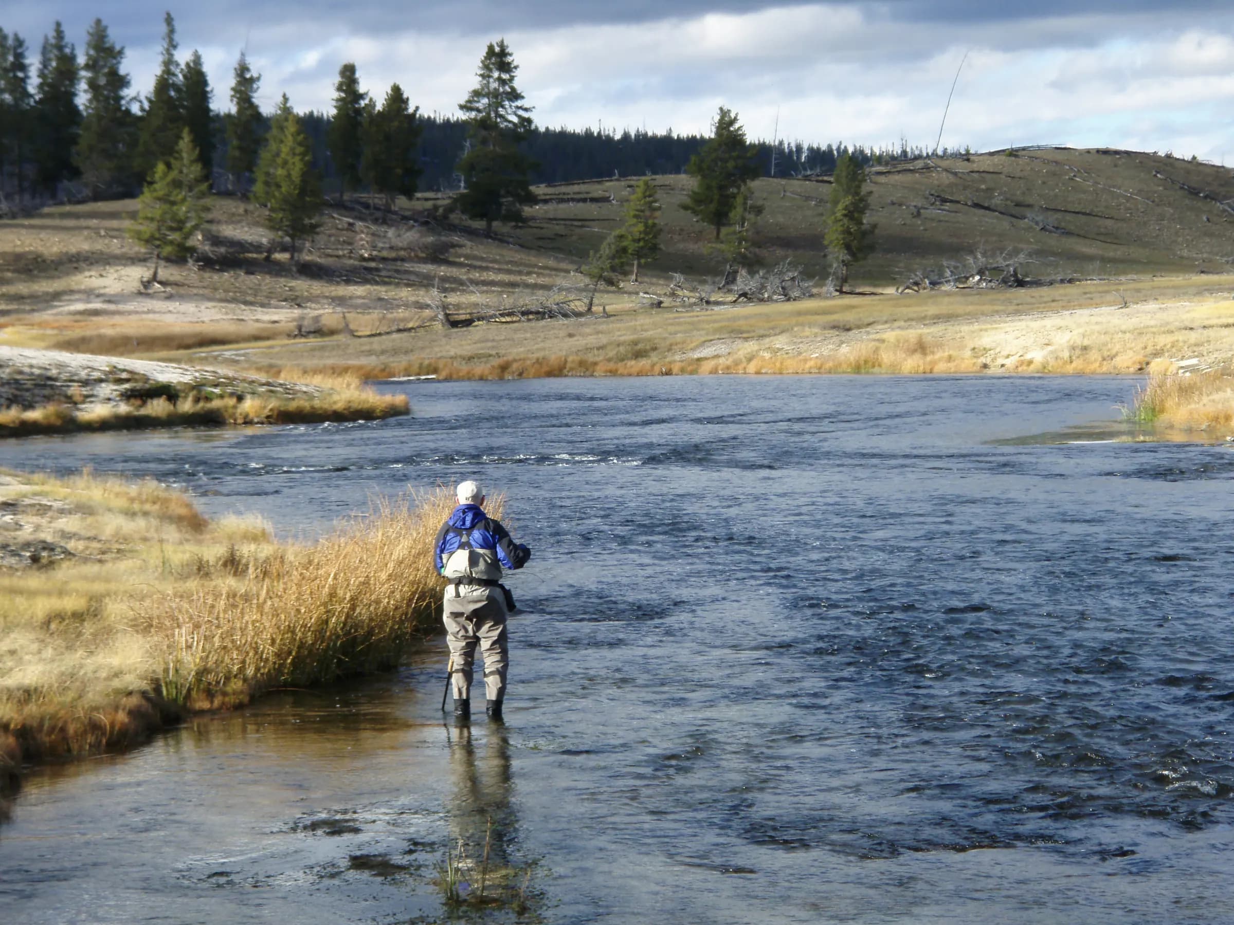 An angler fly fishing the Firehole River