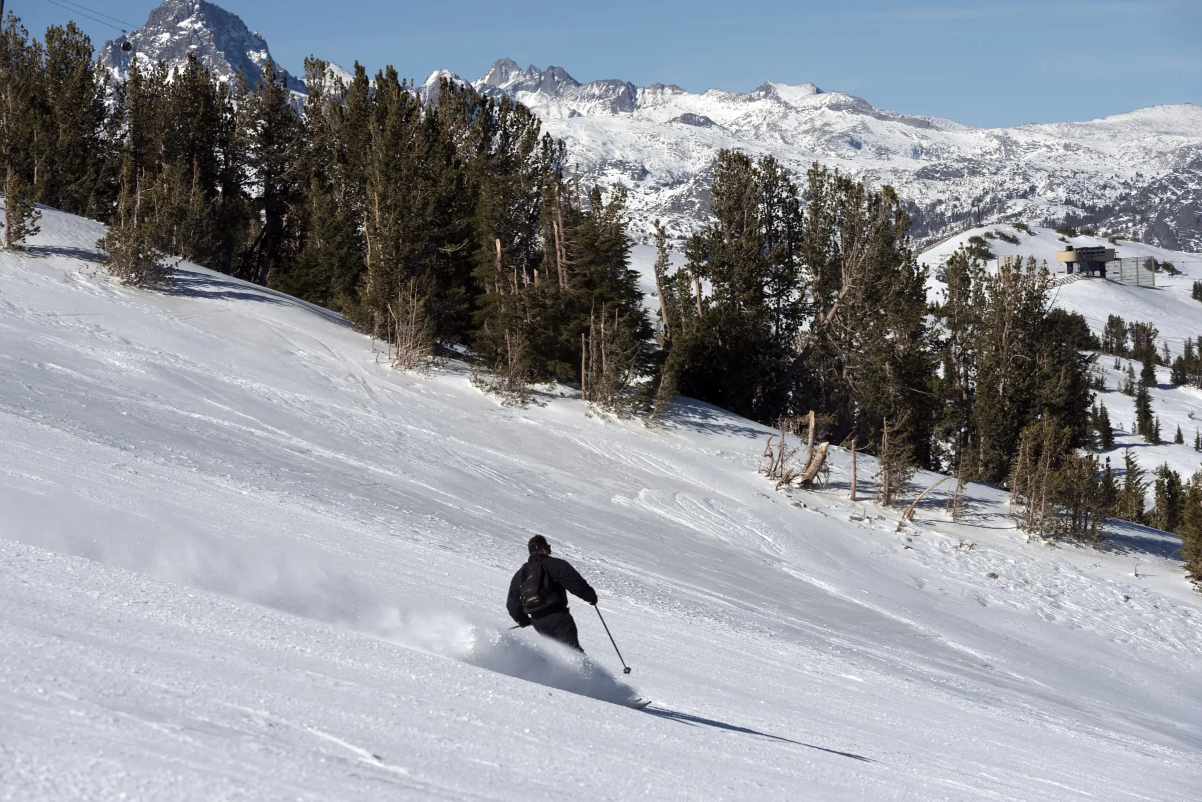 A skier on snowy terrain at Mammoth Mountain